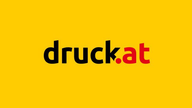 Logo von druck.at: schwarzer Schriftzug „druck“ und roter Schriftzug „.at“ auf gelbem Grund